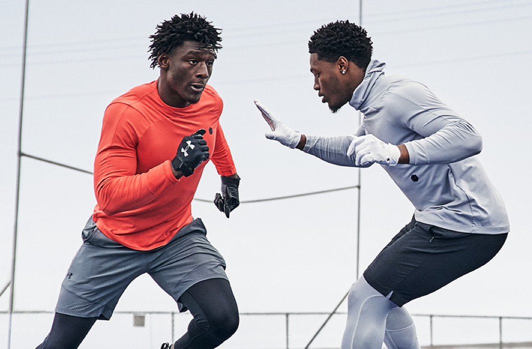 2 guys running football drills outside wearing UA RUSH ColdGear baselayer & shorts for enhanced perf