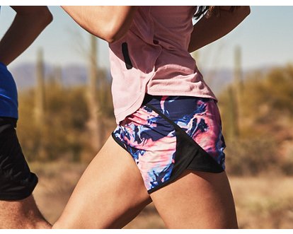 Under Armour Fly By 2.0 shorts in light pink with contrast piping